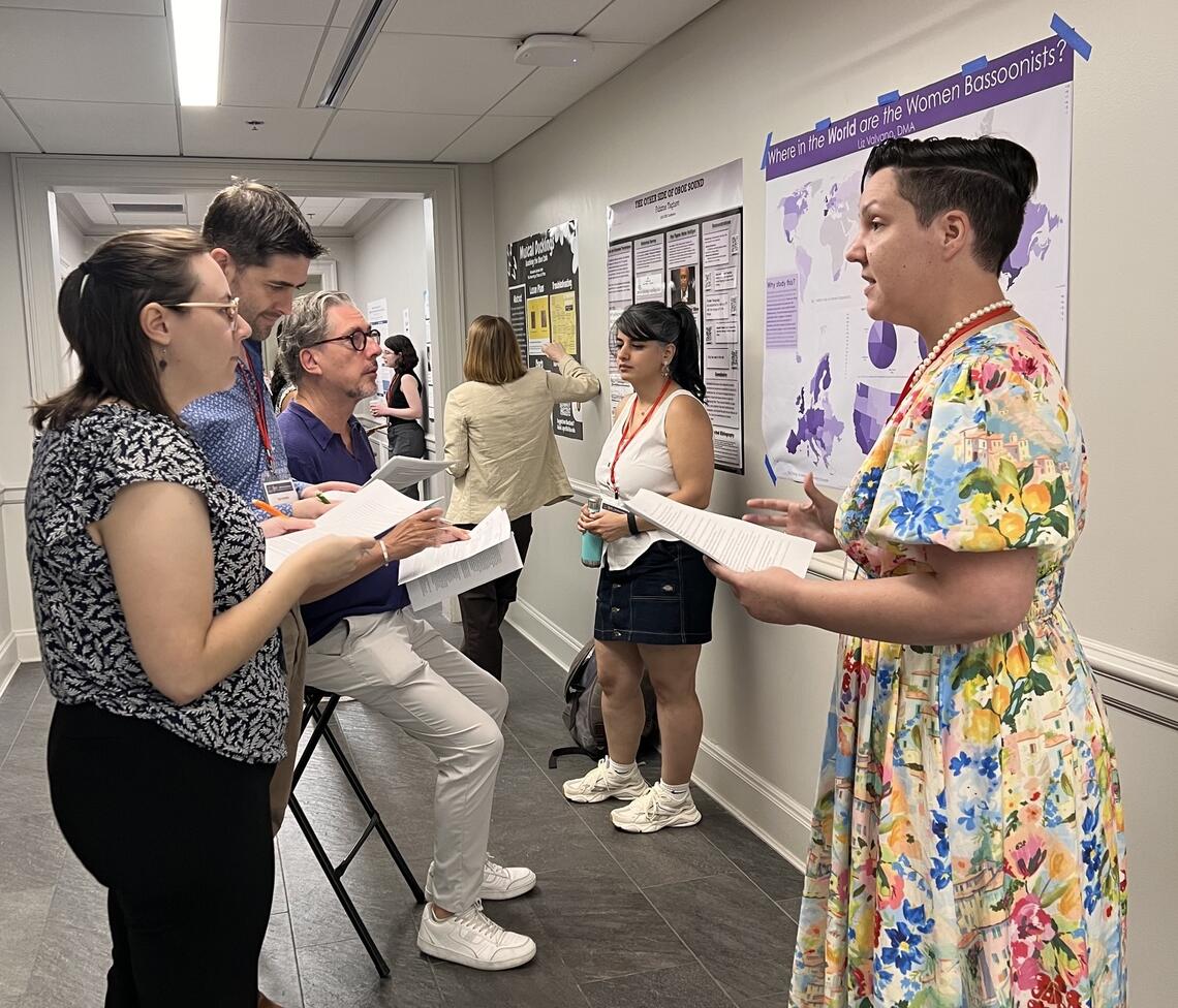 A group of academics speaking to each other in front of research posters