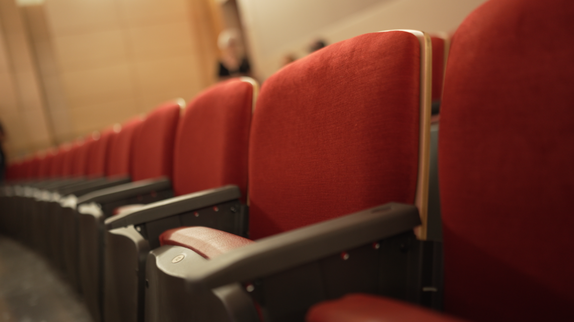 Red seats inside Doc Rando Recital Hall