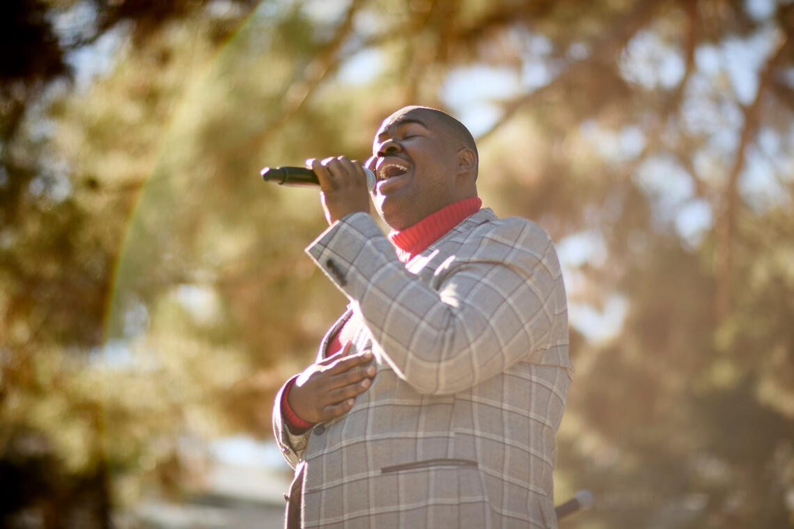 photo of man signing into mic