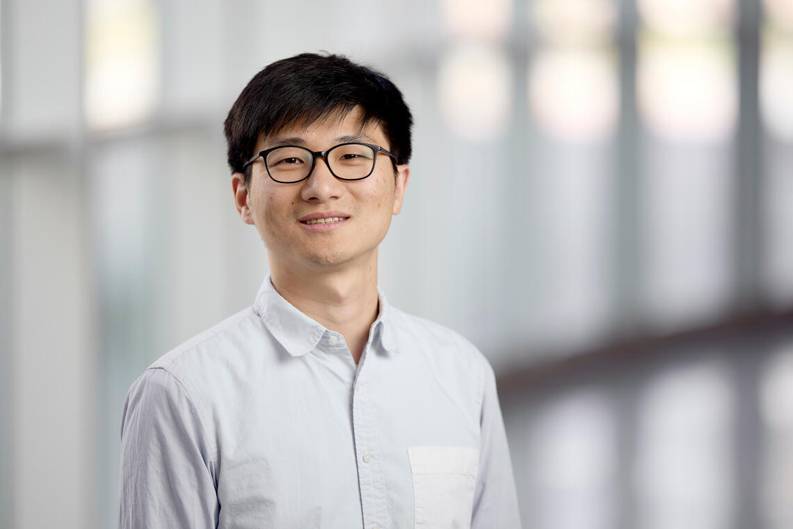 photo of bespeckled man smiling into the camera