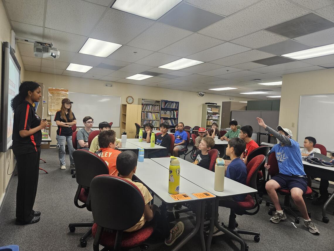 A group of UNLV students teaching a STEM class on fire science to children in grades 6 to 8.