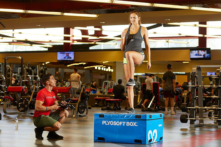 Student doing an exercise next to an instructor