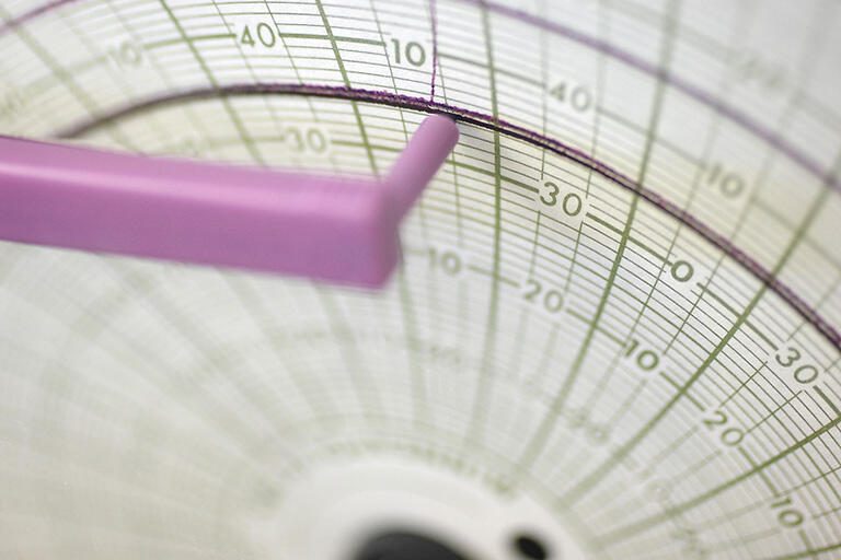 Graph being written on by a mechanical arm