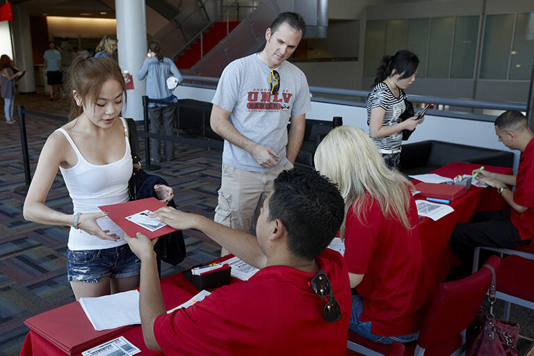 Students getting assistance from a help staff