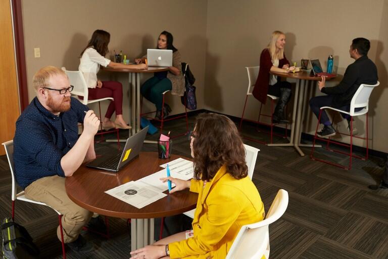 Group of people talking around desks