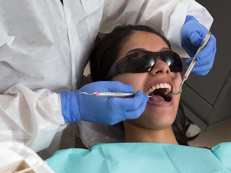 Patient having teeth cleaned at a Dental Clinic.