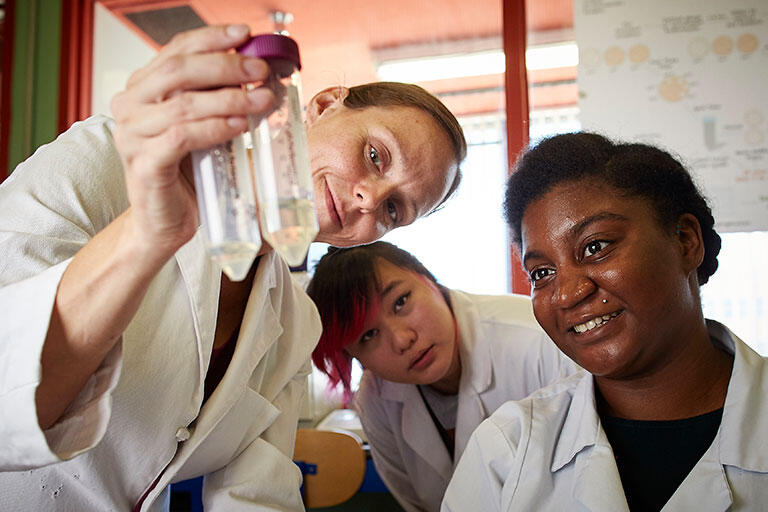 Scientists looking at flask