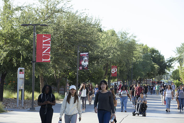 students walking along campus grounds