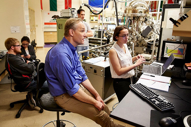 Faculty and students working in a lab