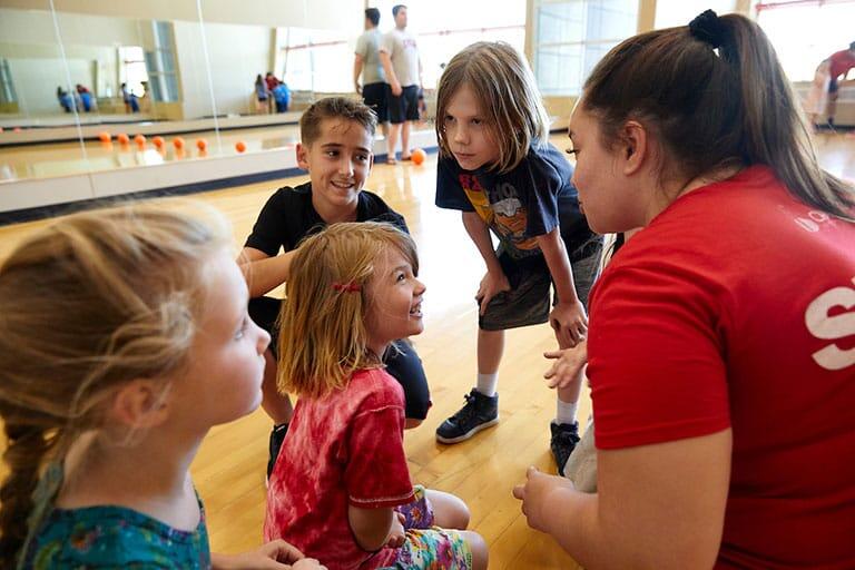 Kids doing a variety of activities at the SRWC Junior Rebels Camp.
