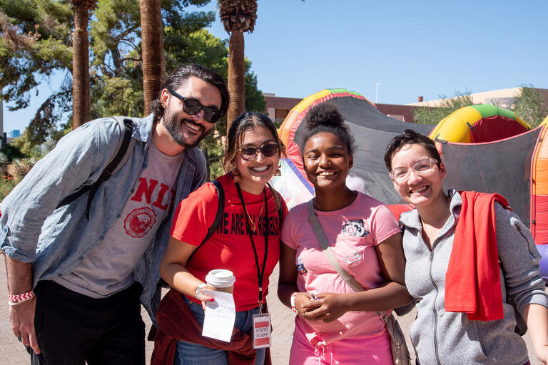 A family of four, all wearing U-N-L-V swag, posing together for a picture