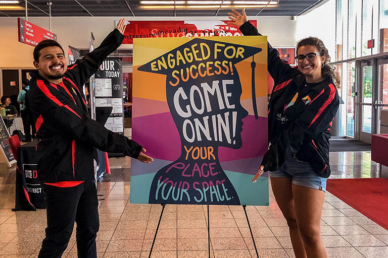 People in the student union holding a sign saying "Engaged for success! Come on in! Your place, your space."