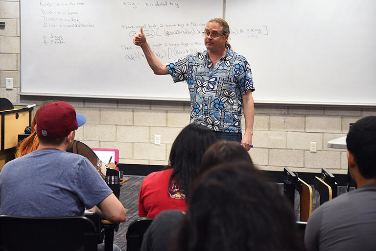 A professor teaching in a classroom.