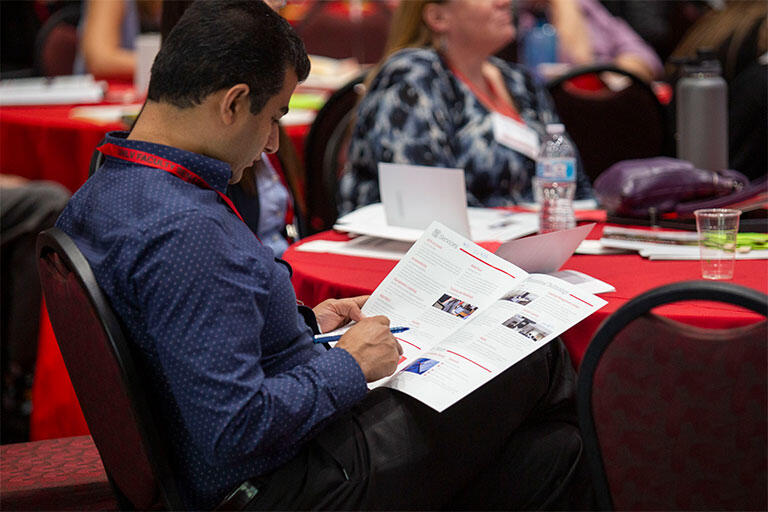 A man looking at a flyer