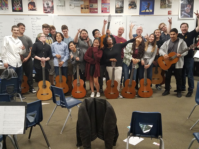 A group of students holding guitars