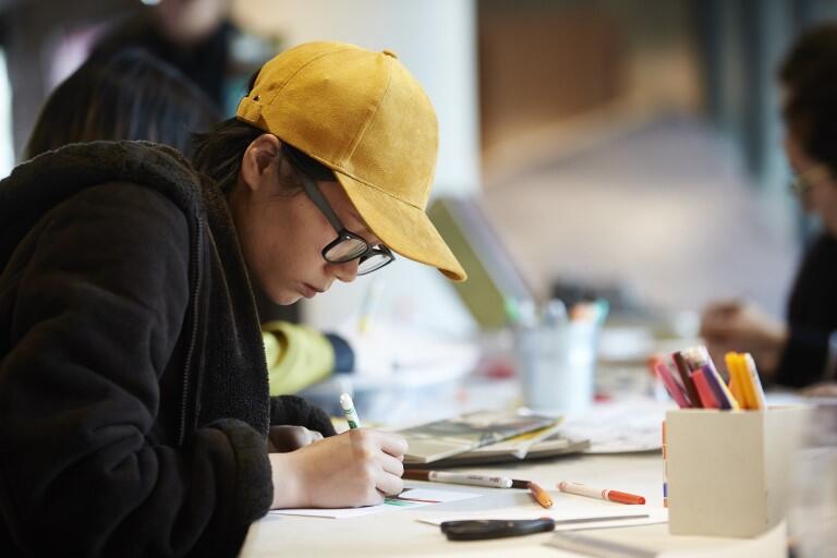 Person writing on a notebook