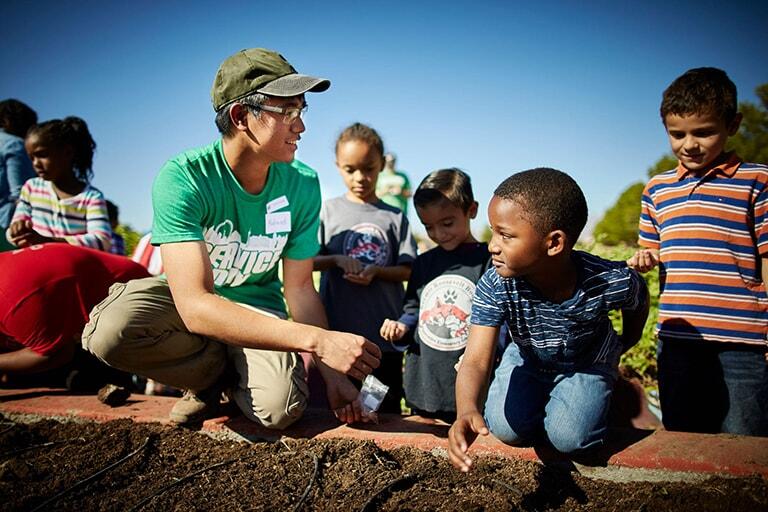 A student working with community children on service day