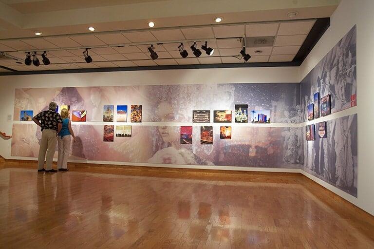 Two visitors looking at art