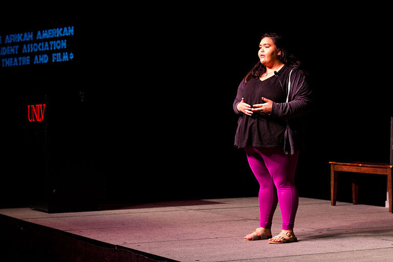 A female student giving a presentation at an event.