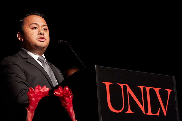 A student speaking from a podium 