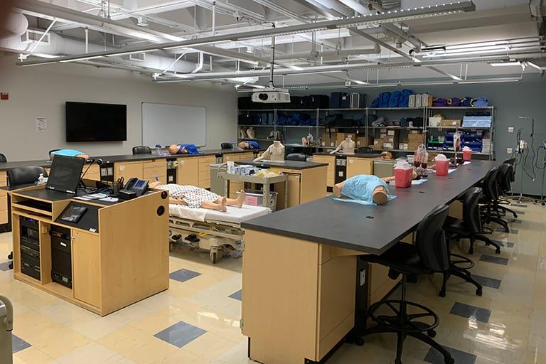 A lab with simulation manikin in the center of the room