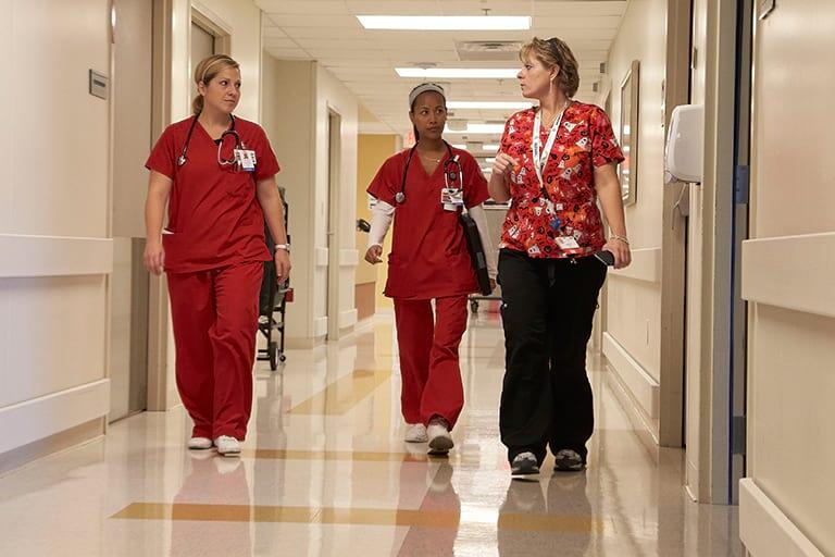 Nurses walking down a hallway.