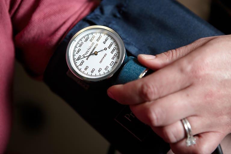 A nurse getting their blood pressure checked.