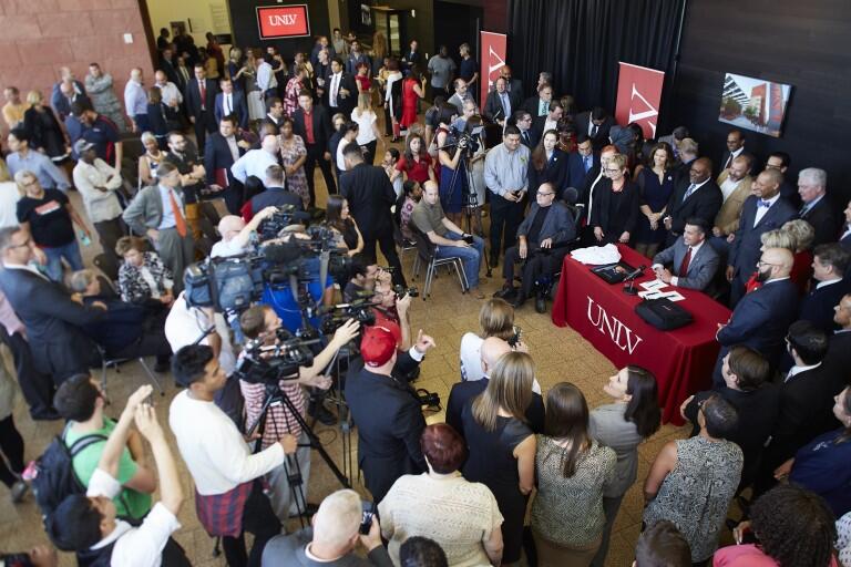 Group of several people surrounding a table