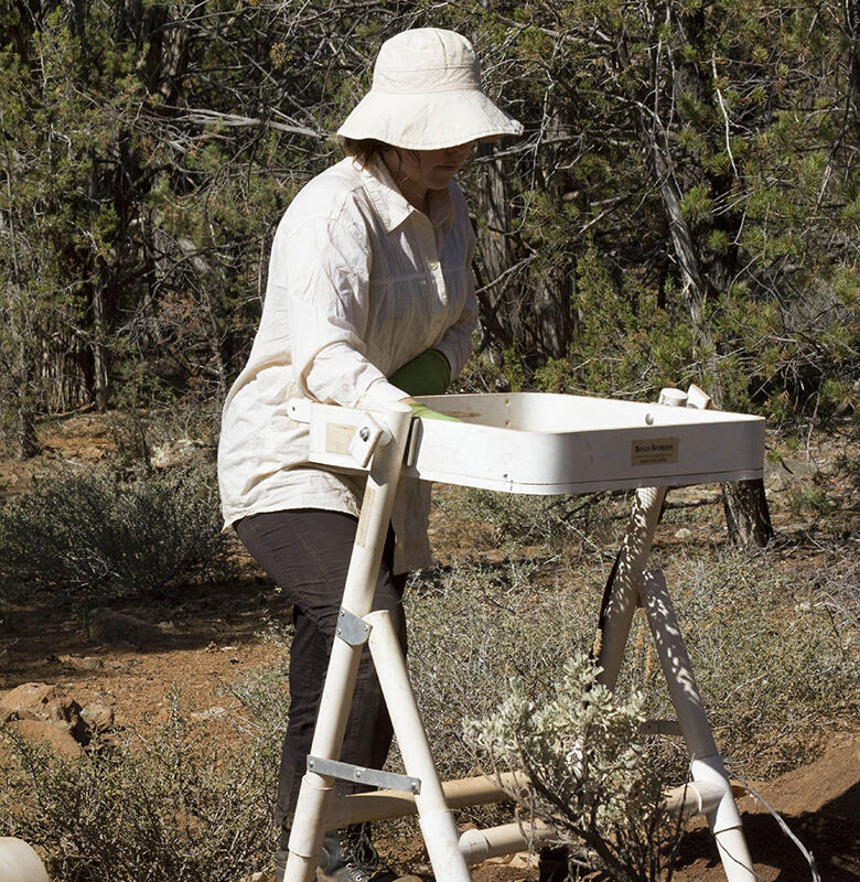 A woman holding up a tray