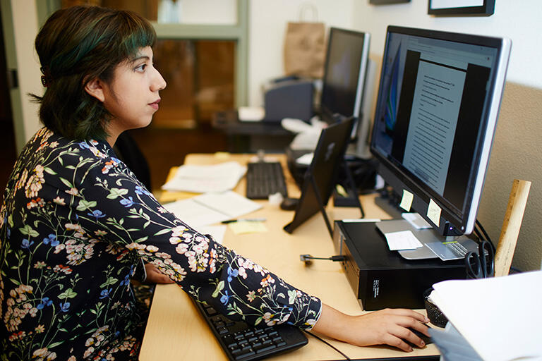 A woman looking at a computer screen.