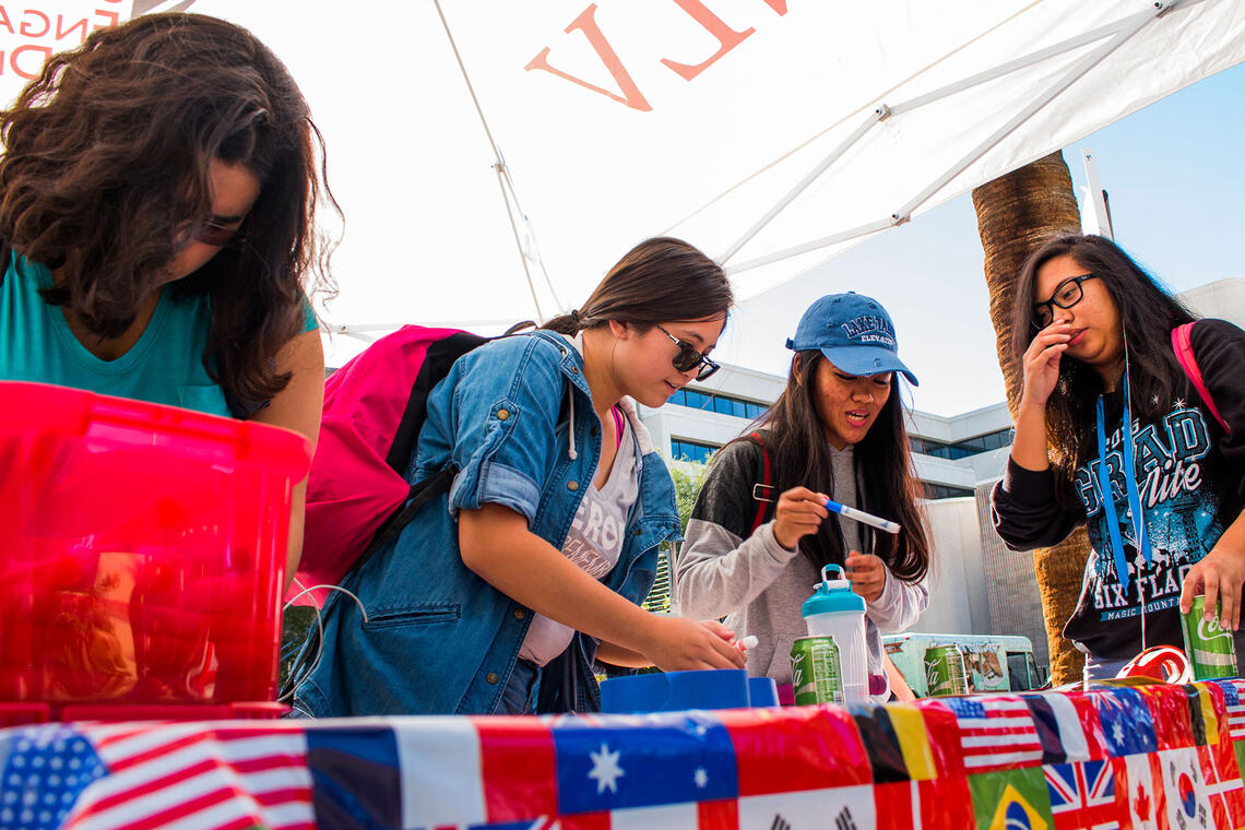 Students looking at things in a booth