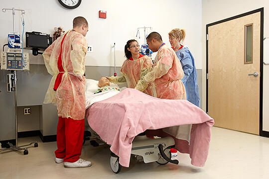 Students practice on a dummy