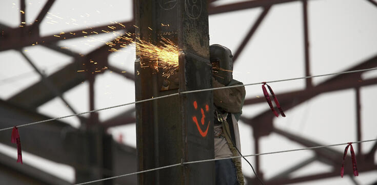 Man welding up on a pole