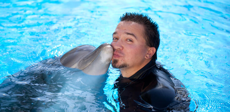 Man swimming with a dolphin