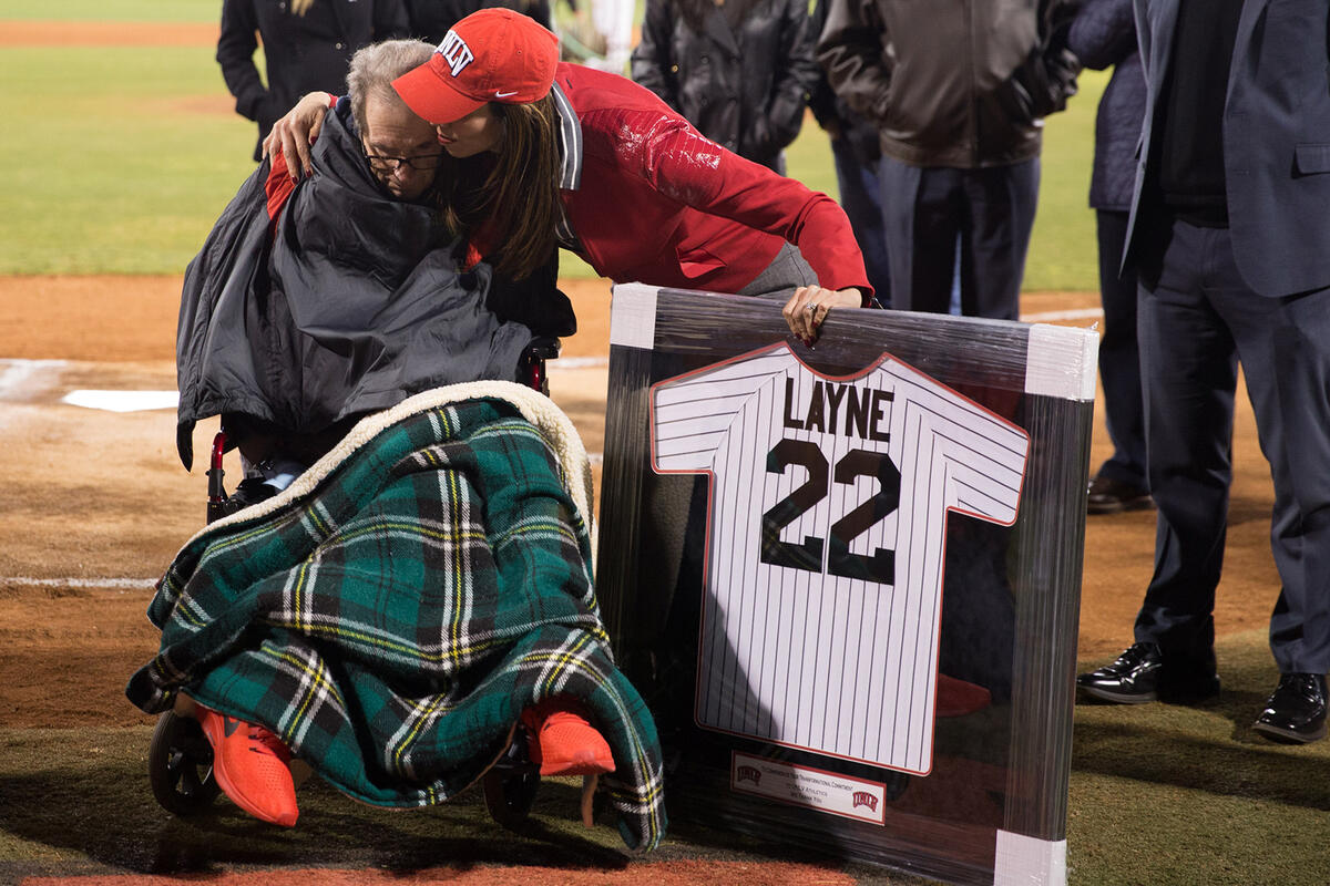 man in wheelchair receiving honorary jersey