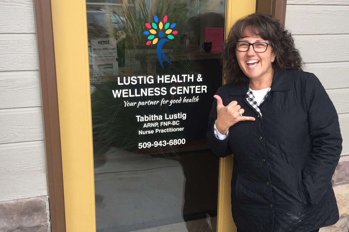 woman outside entrance to medical office