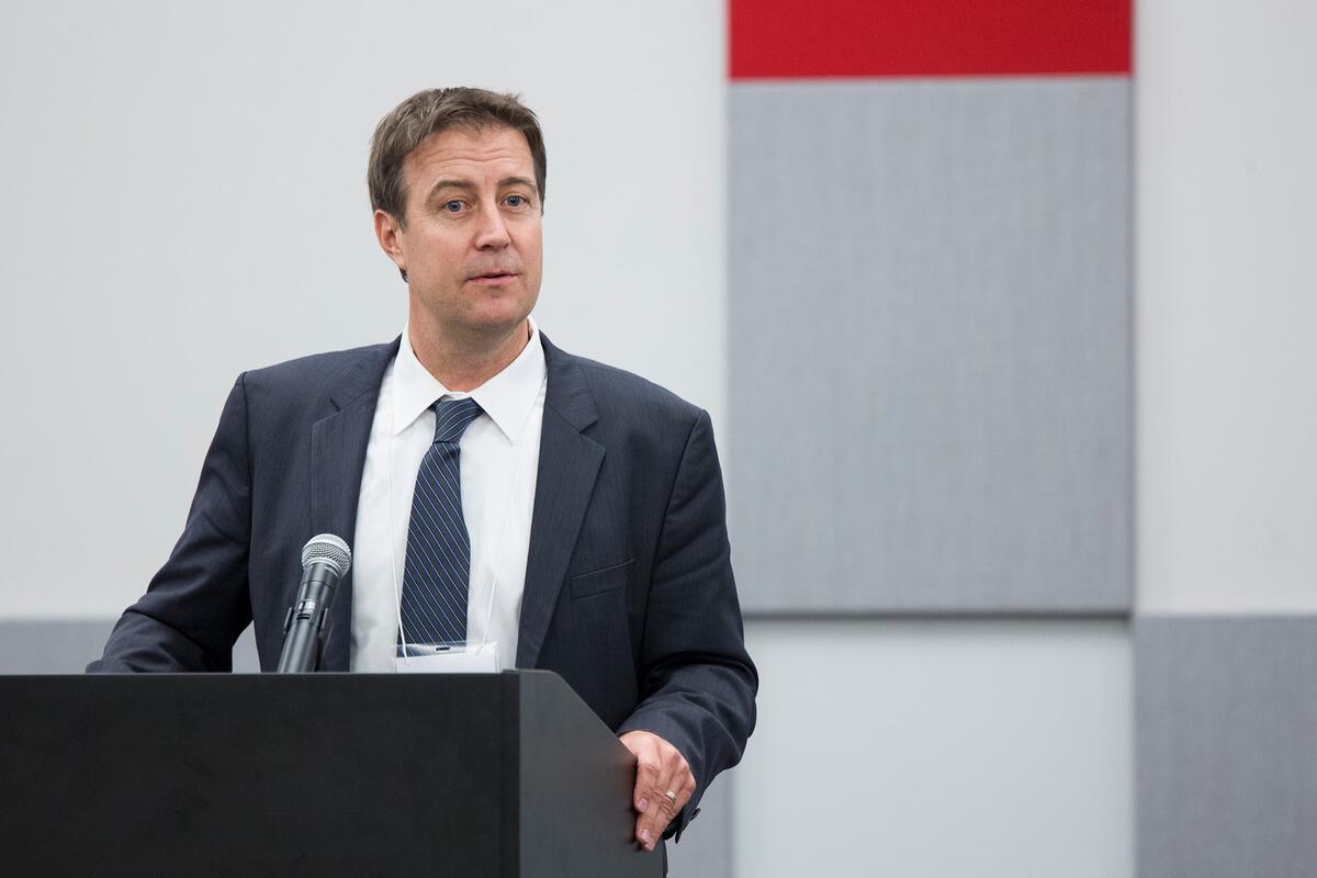 Bo Bernhard speaks at a podium