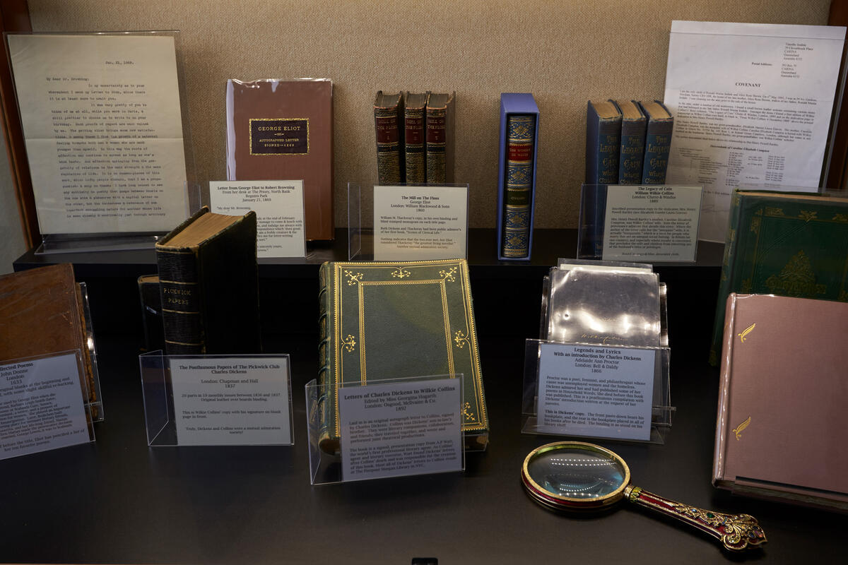 A series of books are displayed in a case