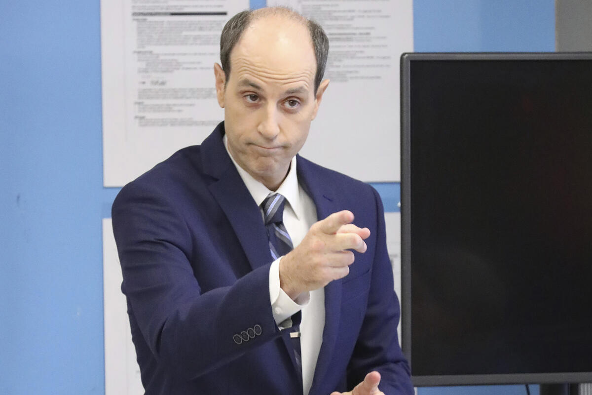 A man raising his arm up and his hand in a pointing pose