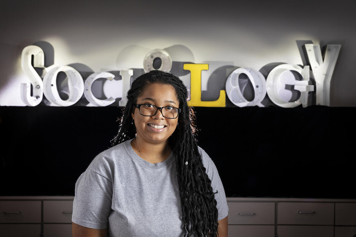 woman in front of sociology sign