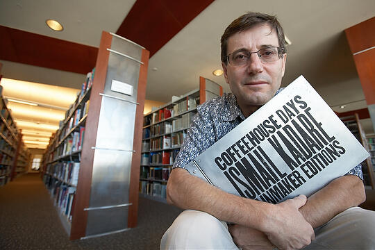 Pirro Dollani poses in a library