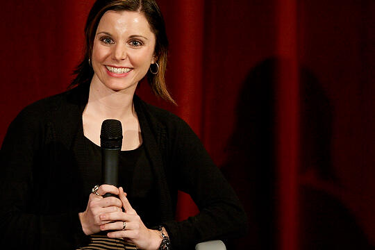 Alumna Alissa Nutting holding a microphone