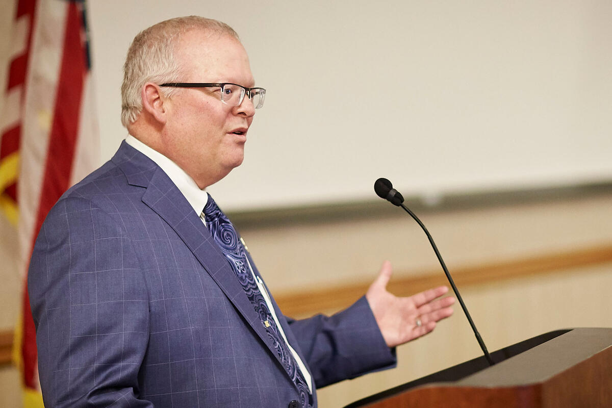 Ross Bryant speaks at podium