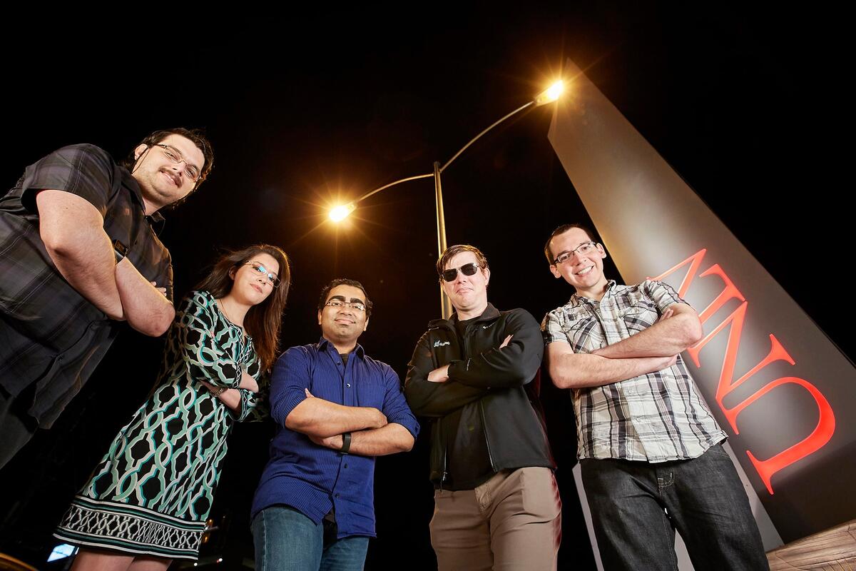 Team Wingin' It stands in front of U.N.L.V. sign