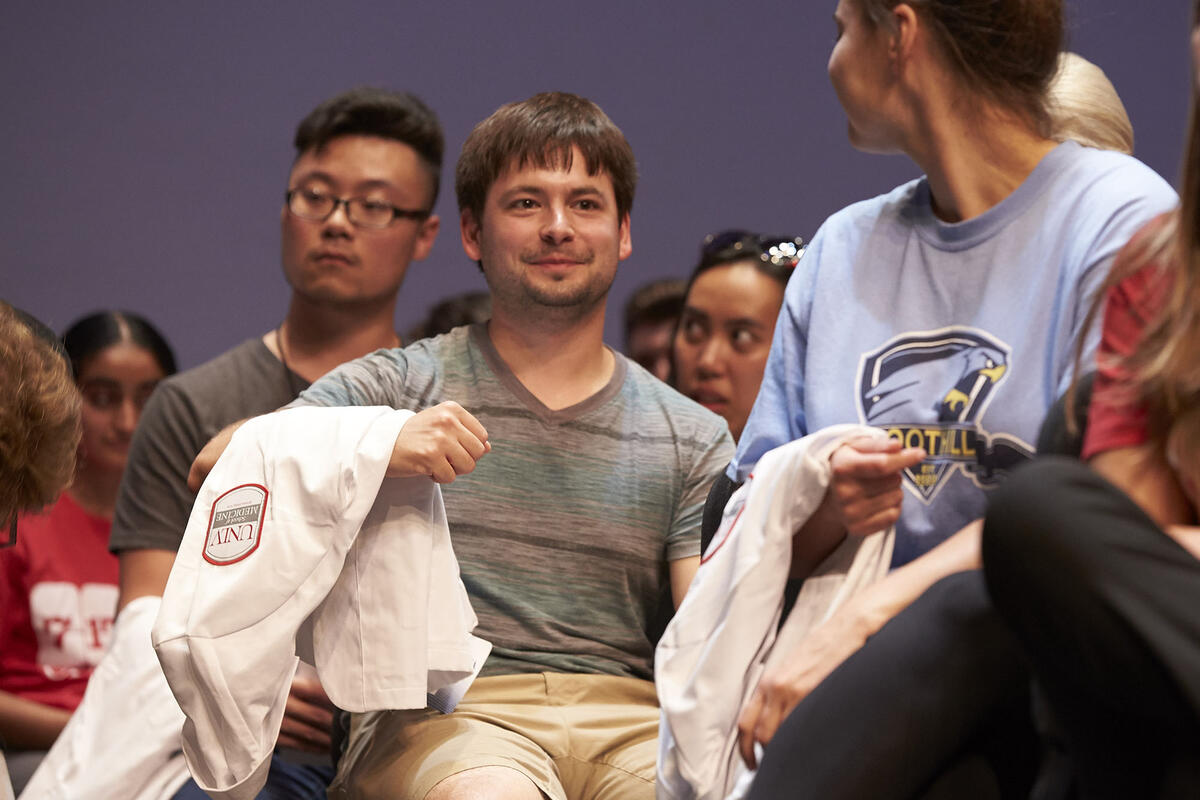 man holding doctor's coat
