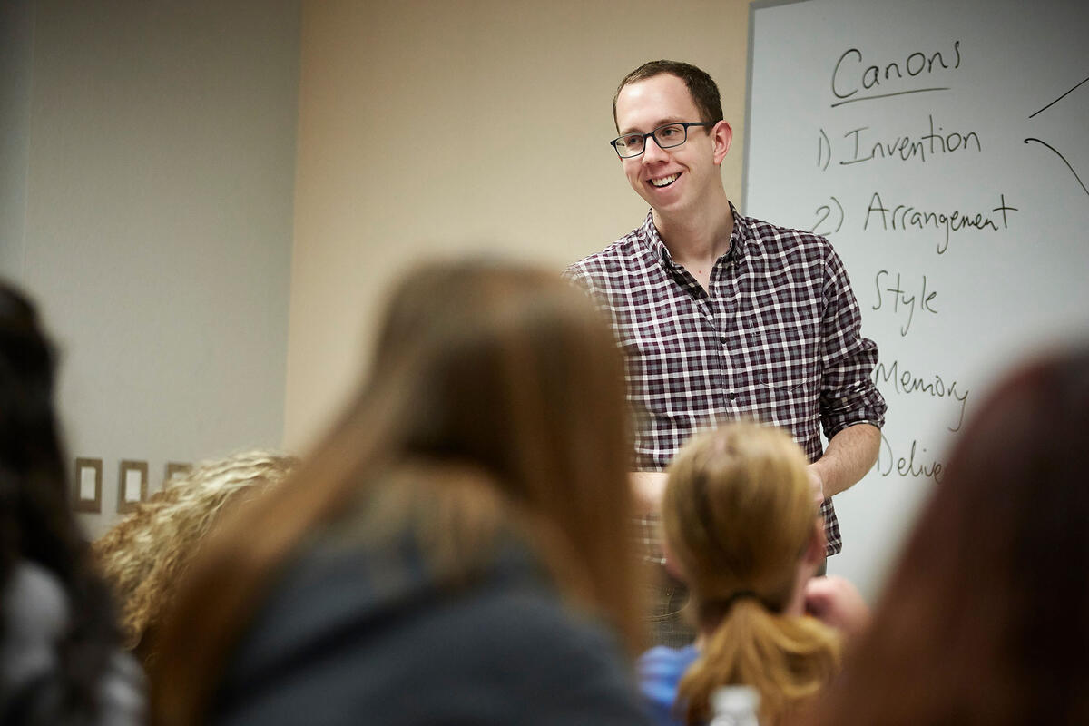 Bryan Blankfield standing at whiteboard in front of students
