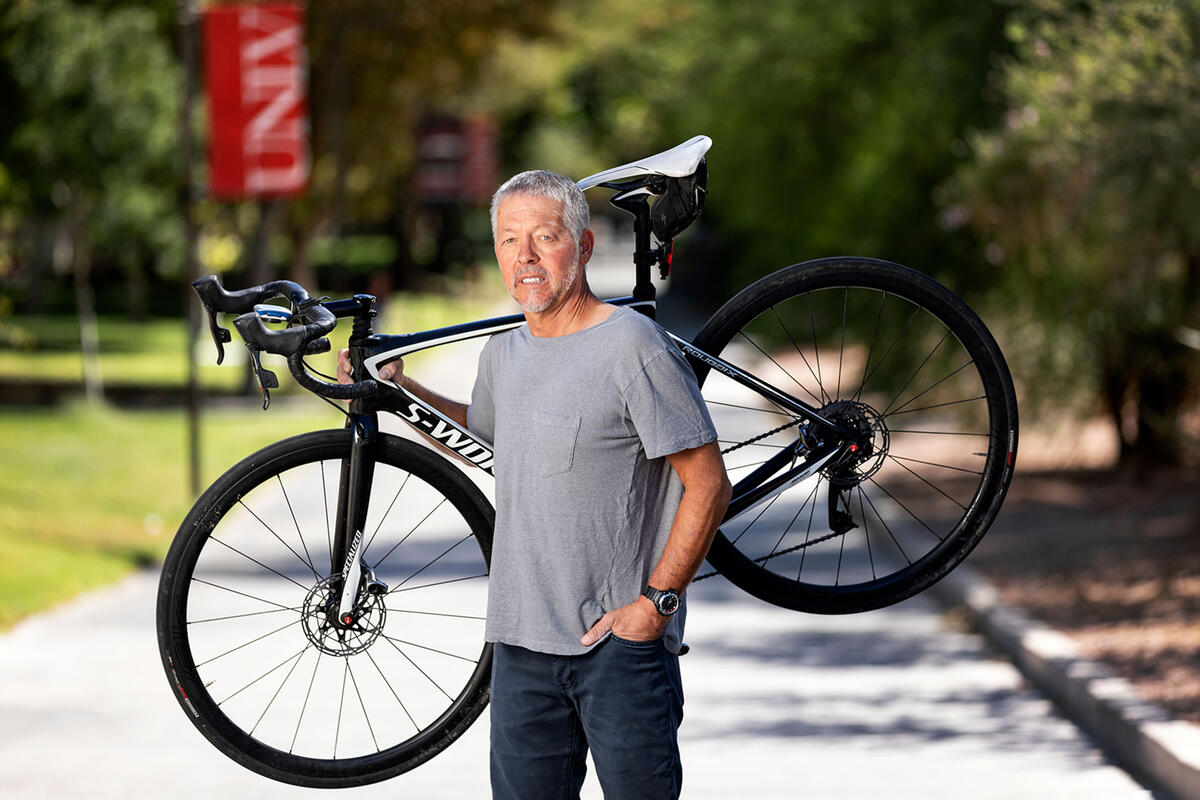 Brett Riddle holding a bike.