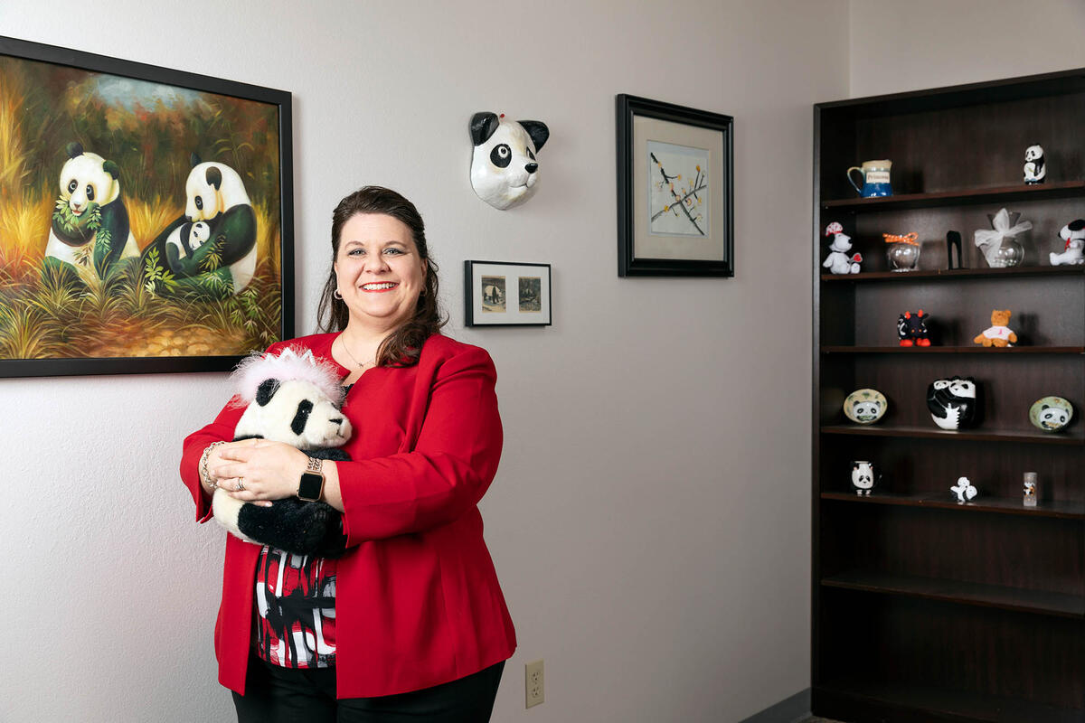 Lori Ciccone, the executive director of the office of sponsored programs, poses in her office.