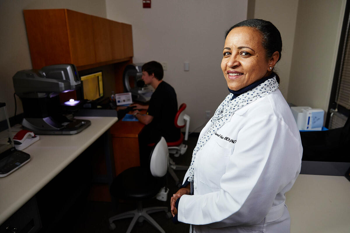 Dr. Neamat Hassan poses in front of student Jared Link, who is conducting research.