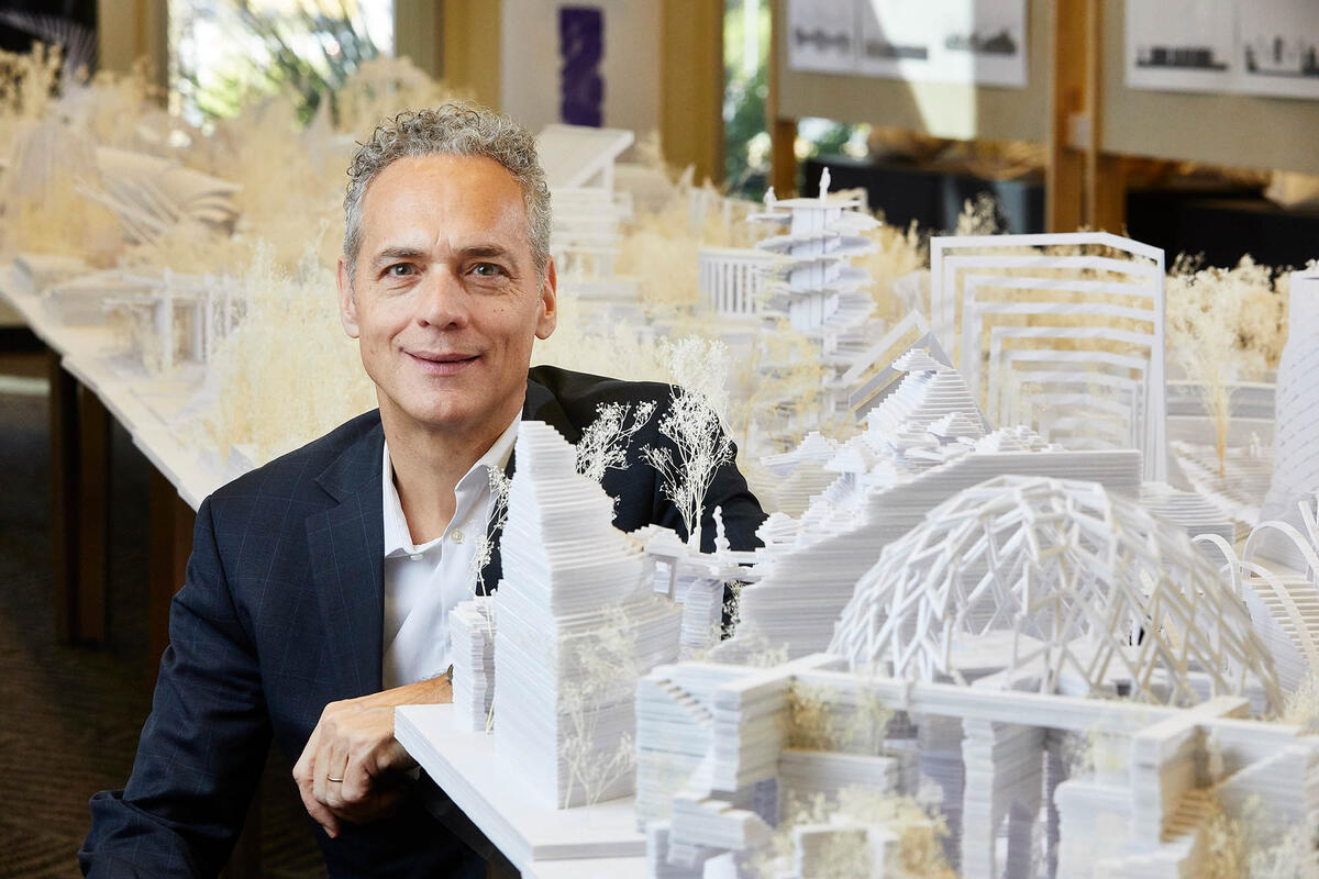 Steffen Lehmann poses in front of architectural models.